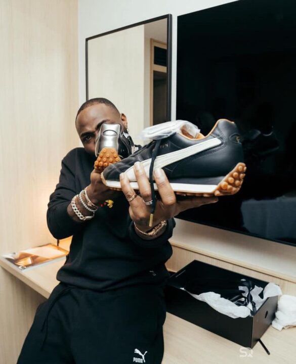 Puma sneakers in the hand of Davido